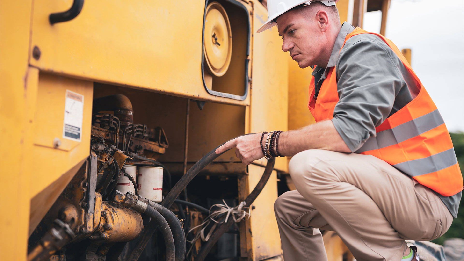 mechanic performing excavator maintenance